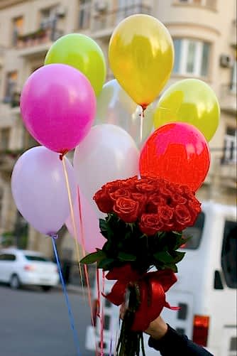 Coloured balloons and  rose bouquet